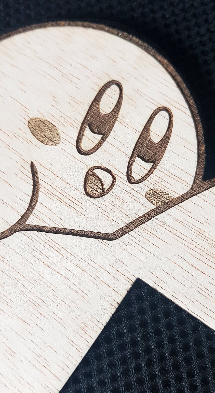 Primer plano del trazo de un grabado a láser sobre madera